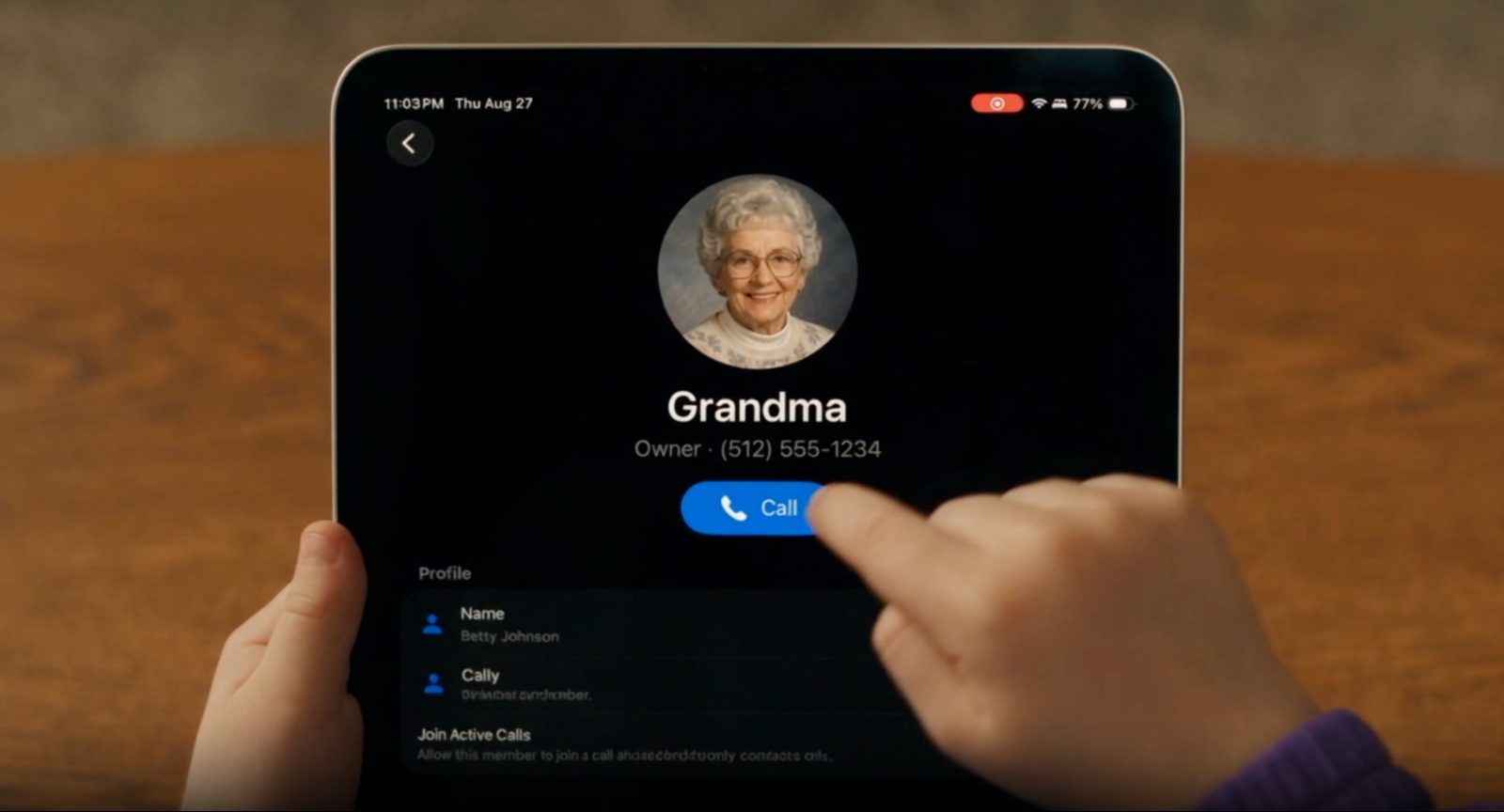 A child holding an iPad to make a phone call.